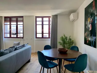 a living room with a couch and a table and chairs at Oporto Chic&Cozy - Batalha II in Porto