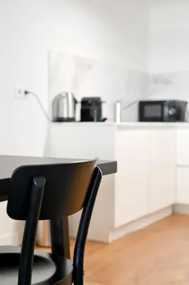 a black chair sitting in front of a kitchen counter at Oporto Chic&Cozy - Batalha II in Porto