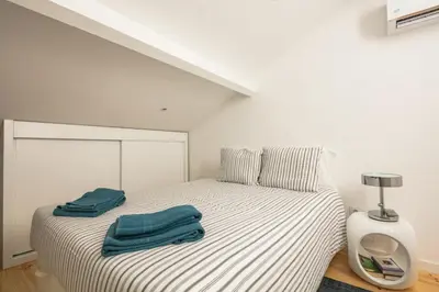 a bedroom with a bed with two blue towels on it at New Bluebell house in heart of Porto in Porto