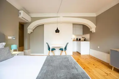 a bedroom with a bed with red pillows at MyStay Porto - Urban Collection in Porto