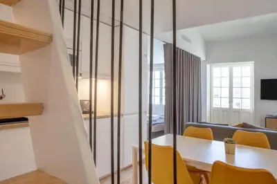 a dining room with a table and yellow chairs at MyStay Porto - Urban Collection in Porto