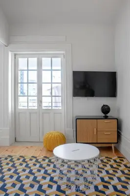 a bedroom with a bed and a flat screen tv at MyStay Porto - Urban Collection in Porto