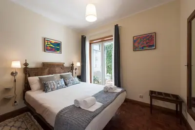 a bedroom with a large bed with towels on it at LovelyStay - Heritage Collection House with 4Bedrooms in Porto