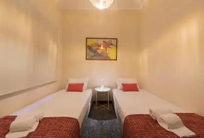 a room with two beds and a table in it at LovelyStay - Heritage Collection House with 4Bedrooms in Porto