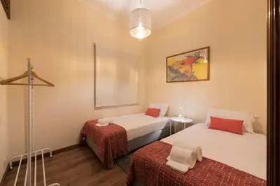 a room with two beds and a lamp at LovelyStay - Heritage Collection House with 4Bedrooms in Porto