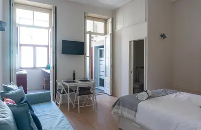 a bedroom with a bed and a desk in it at Jardim de São Lázaro - Porto Apartments in Porto
