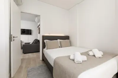 a bedroom with two beds and a couch at Bra.com Apartments Oporto Faria Guimarães in Porto