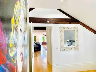 a hallway with a mirror on a white wall at Spacious Apartment in Porto with Terrace in Porto