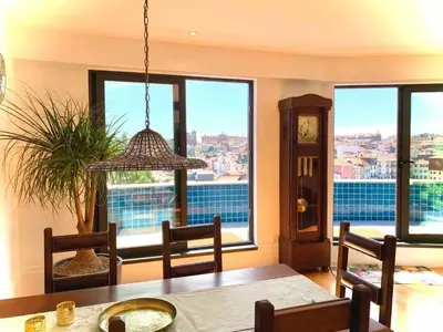 a dining room with a table and some windows at Spacious Apartment in Porto with Terrace in Porto
