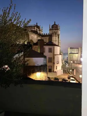 a large white building with a tower on top of it at Spacious Apartment in Porto with Terrace in Porto