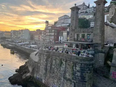a group of people standing on a wall near the water at Spacious Apartment in Porto with Terrace in Porto