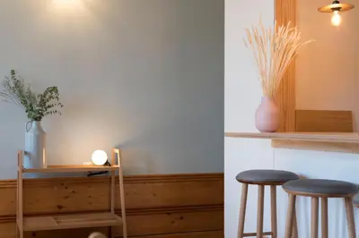 a room with two stools and a table with a vase at Cardosas Palace Apartment in Porto