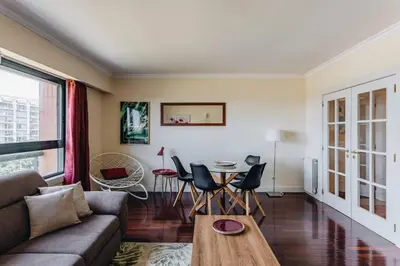 a living room with a couch and a table at Spacious 1BR with Parking in Quiet Area in Vila Nova de Gaia