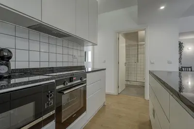 a kitchen with a stove and a counter top at Travel and Live Apartments in Porto