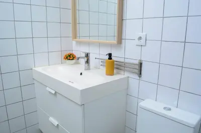 a white bathroom with a sink and a mirror at Travel and Live Apartments in Porto