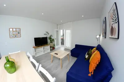 a living room with a blue couch and a table at Travel and Live Apartments in Porto