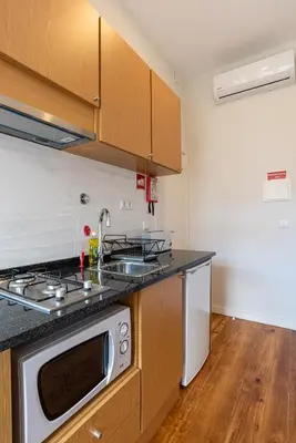 a kitchen with a sink and a stove top oven at ZD Moreira Flats B By PortoProperties4You in Porto
