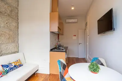 a living room with a white couch and a table at ZD Moreira Flats B By PortoProperties4You in Porto