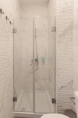 a shower with a glass door in a bathroom at ZD Moreira Flats B By PortoProperties4You in Porto