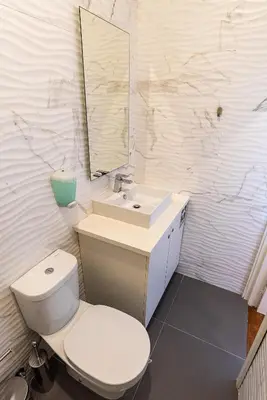 a bathroom with a toilet and a sink and a mirror at ZD Moreira Flats B By PortoProperties4You in Porto