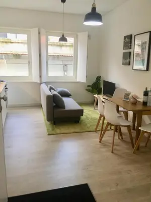 a living room with a couch and a table at Porta de São Bento in Porto