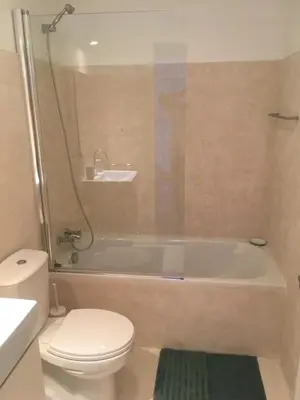 a bathroom with a tub and a toilet and a sink at Porta de São Bento in Porto