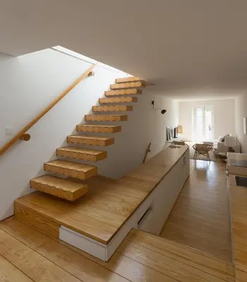 a staircase in a house with wooden floors at Casa Castanha in Porto