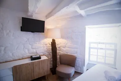 a bedroom with a chair and a tv on a wall at Porto & Douro Best Views by PCH in Porto