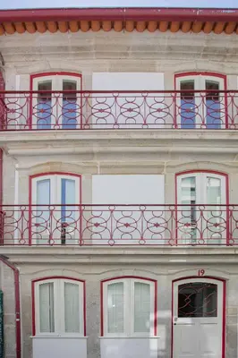 a building with a red balcony on top of it at Liiiving in Porto - Cozy & Chic Downtown in Porto