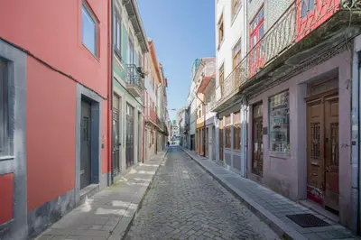 an empty street in an alley with buildings at Liiiving in Porto - Cozy & Chic Downtown in Porto