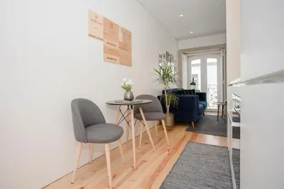 a living room with a table and two chairs at Liiiving in Porto - Cozy & Chic Downtown in Porto