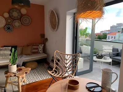 a living room with a couch and a table at Oak Valley Flats Porto Santa Catarina in Porto