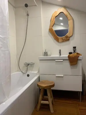 a bathroom with a sink and a tub and a stool at Oak Valley Flats Porto Santa Catarina in Porto