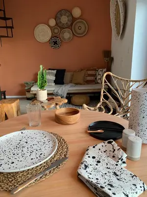a wooden table with plates and utensils on it at Oak Valley Flats Porto Santa Catarina in Porto