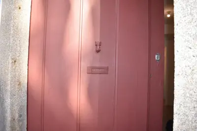 a pink cabinet with a lock on a wall at Casa Barão Forrester in Porto