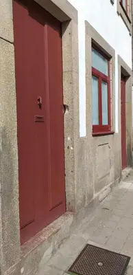 a red door on the side of a building at Casa Barão Forrester in Porto