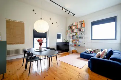 a living room with a table and a couch at Douro Destilaria Residence by Porto City Hosts in Vila Nova de Gaia