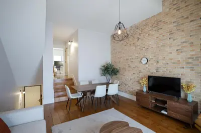 a small white kitchen with a table and chairs at Douro Destilaria Residence by Porto City Hosts in Vila Nova de Gaia