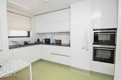 a bedroom with a large bed with a large window at Douro Destilaria Residence by Porto City Hosts in Vila Nova de Gaia