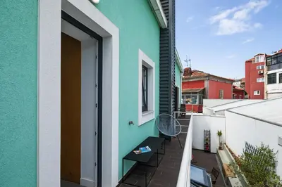 a balcony with a green and white building at Porto Insight Apartments Campanhã in Porto