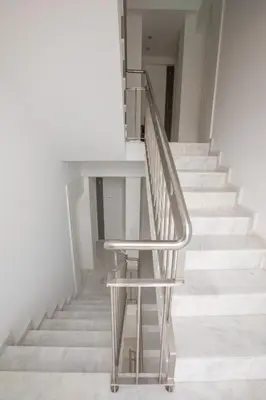 a stair case with a metal chair next to a staircase at Porto Insight Apartments Campanhã in Porto