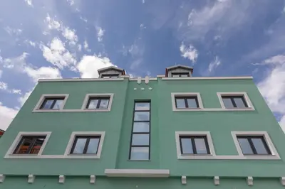 a green building with windows on top of it at Porto Insight Apartments Campanhã in Porto