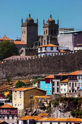 a city with two towers on a hill with buildings at Porto Insight Apartments Campanhã in Porto
