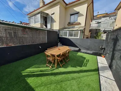 a ping pong table on the grass in a backyard at Ninho Jardim do Morro in Vila Nova de Gaia