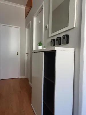 a room with a counter with a mirror and a door at Ninho Jardim do Morro in Vila Nova de Gaia