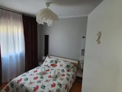 a bedroom with a bed with flowers on it at Ninho Jardim do Morro in Vila Nova de Gaia