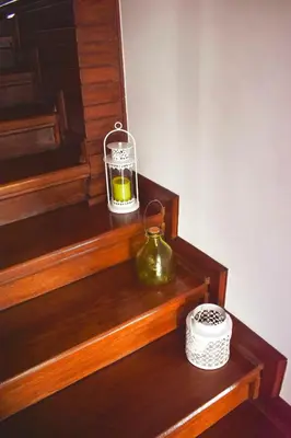 a glass jar sitting on a wooden shelf next to some stairs at Terraço da Boavista in Porto