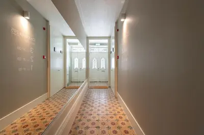 a hallway with doors and a tile floor at Cedofeita Deluxe Apartment 3F in Porto