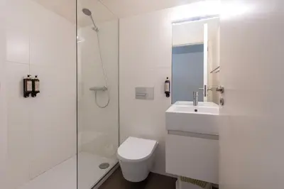 a bathroom with a toilet and a sink and a shower at Cedofeita Deluxe Apartment 3F in Porto