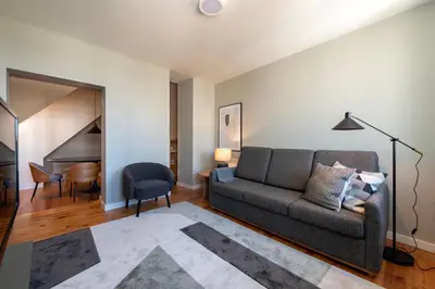 a living room with a couch and a table at Cedofeita Deluxe Apartment 3B in Porto